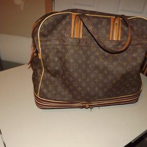 Carry-on size rolling LOUIS  Vuitton luggage bag.  Roller bag.